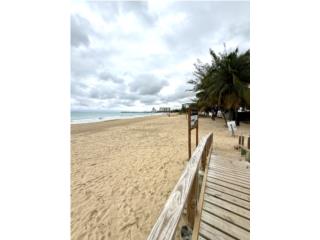 Positioned directly on one of Puerto Rico’s widest and most pristine white-sand beaches, this except